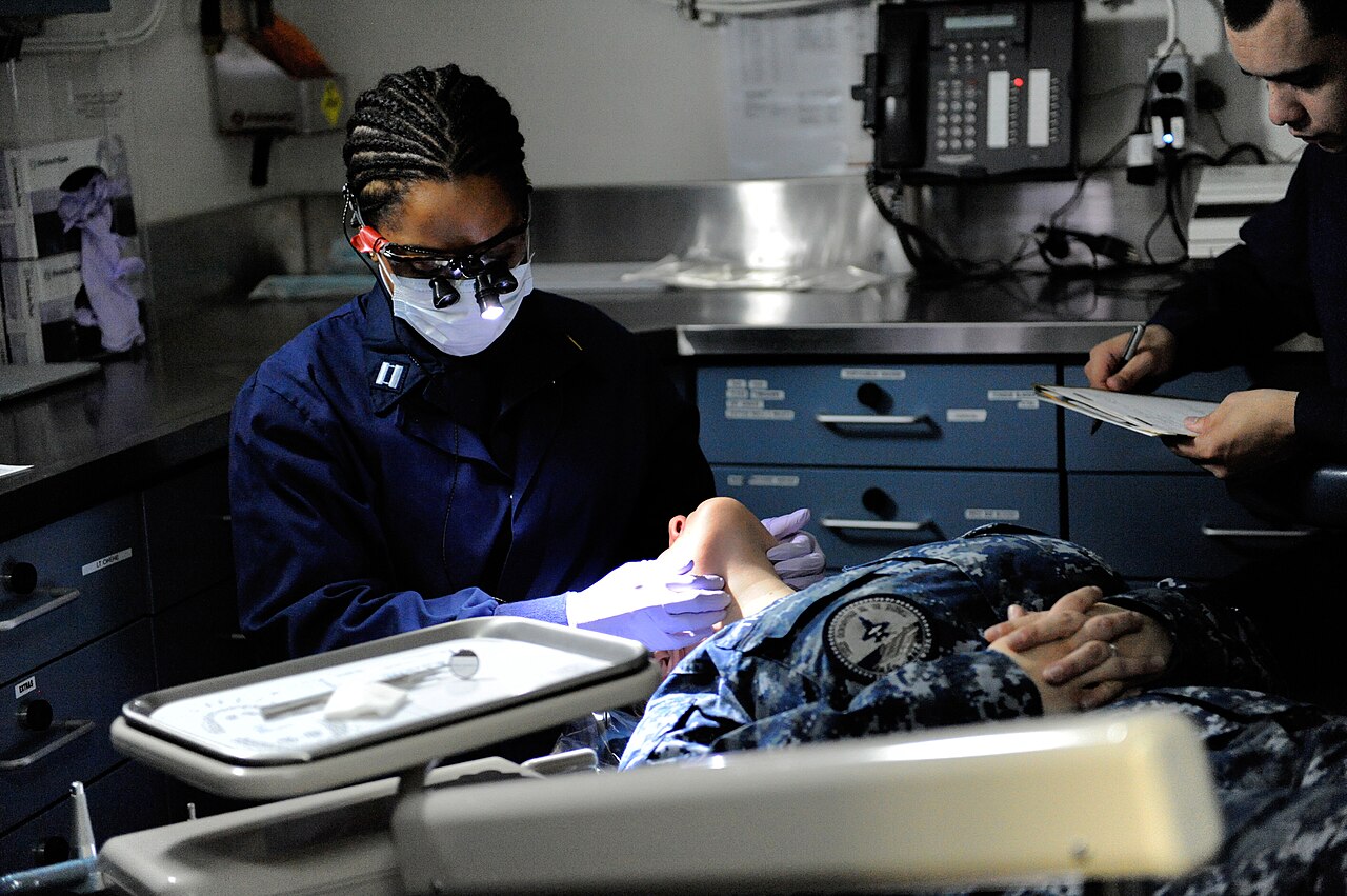 Navy dentist examining a patient